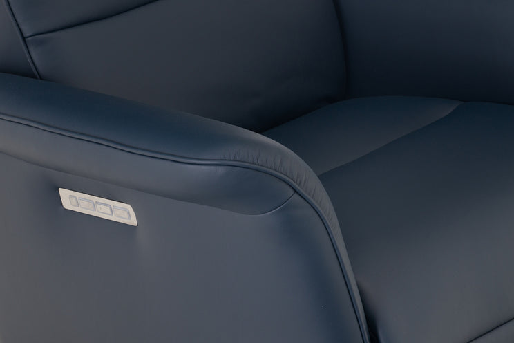 Close-up of a blue leather seat with a visible brand logo.